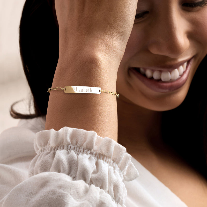 14kt yellow gold ID bracelet with engraved Elizabeth nameplate on wrist
