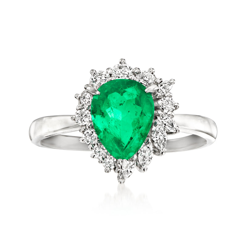 Platinum dinner ring with pear-shaped emerald and diamond halo, prong-set stones