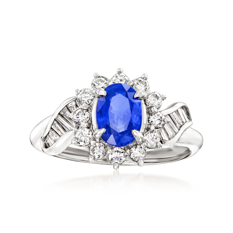 Platinum dinner ring with oval blue sapphire and diamond halo, baguette side accents.