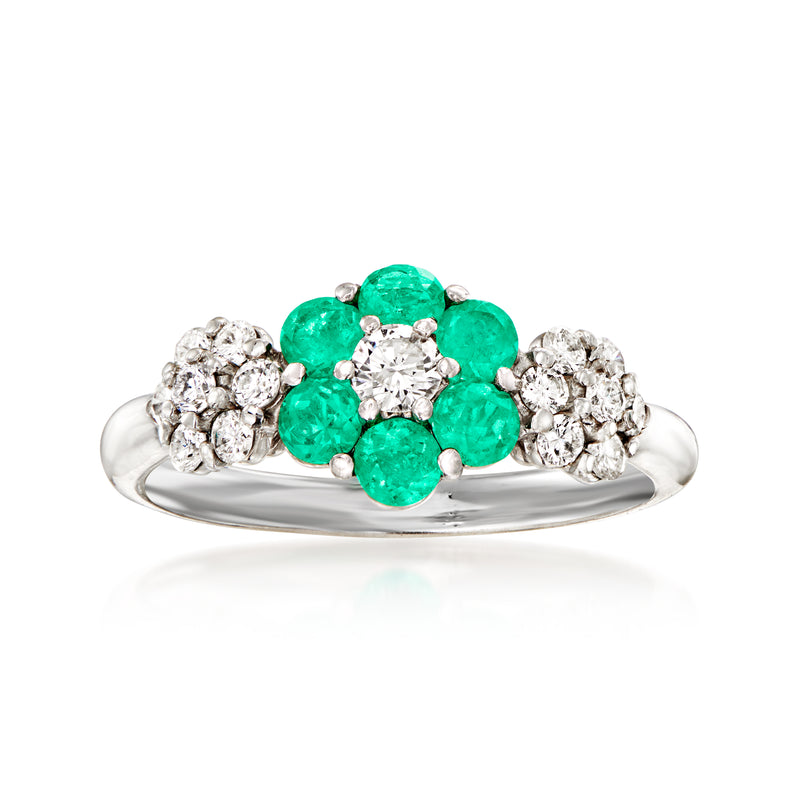 Platinum vintage cocktail ring with emerald-green center flower and diamond clusters