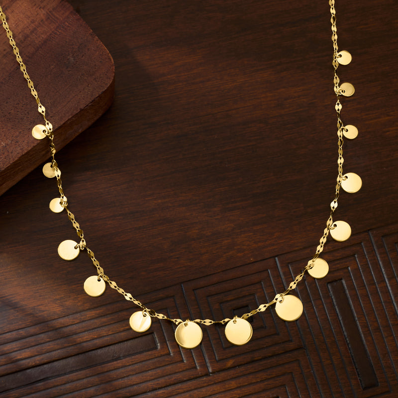 Yellow gold necklace with graduated round disc station charms on a fine chain