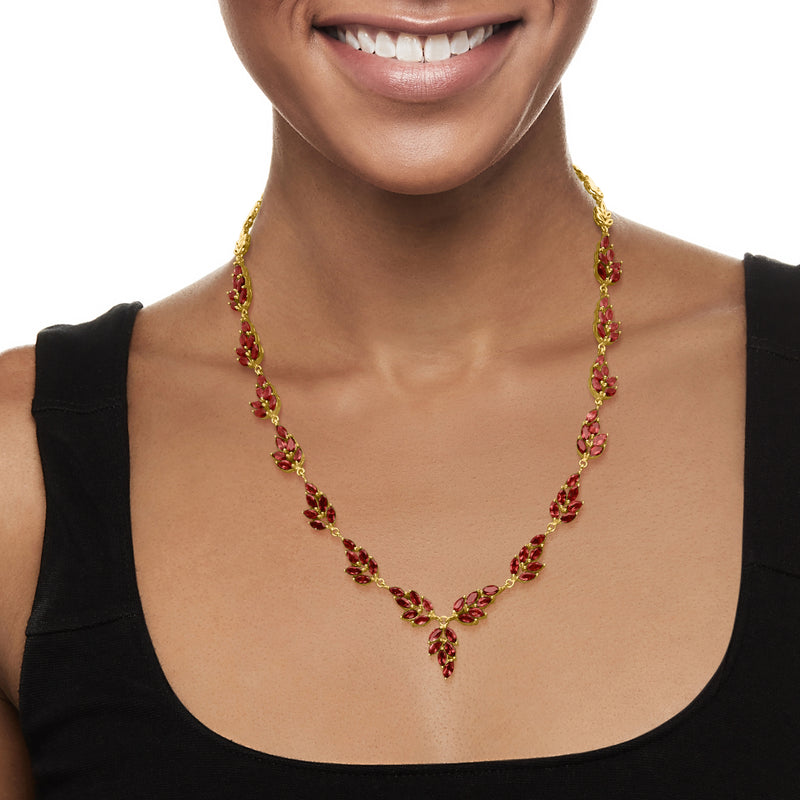 Leaf garnet-stone necklace with gold chain and centered pendant at neckline