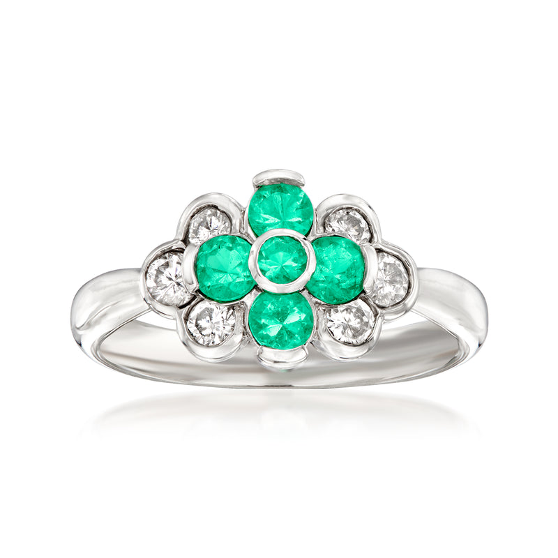Vintage platinum flower ring with green emerald stones and diamond accents