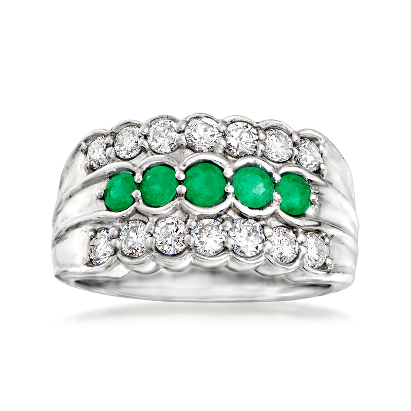 Vintage platinum ring with three green emeralds and round diamonds across the top