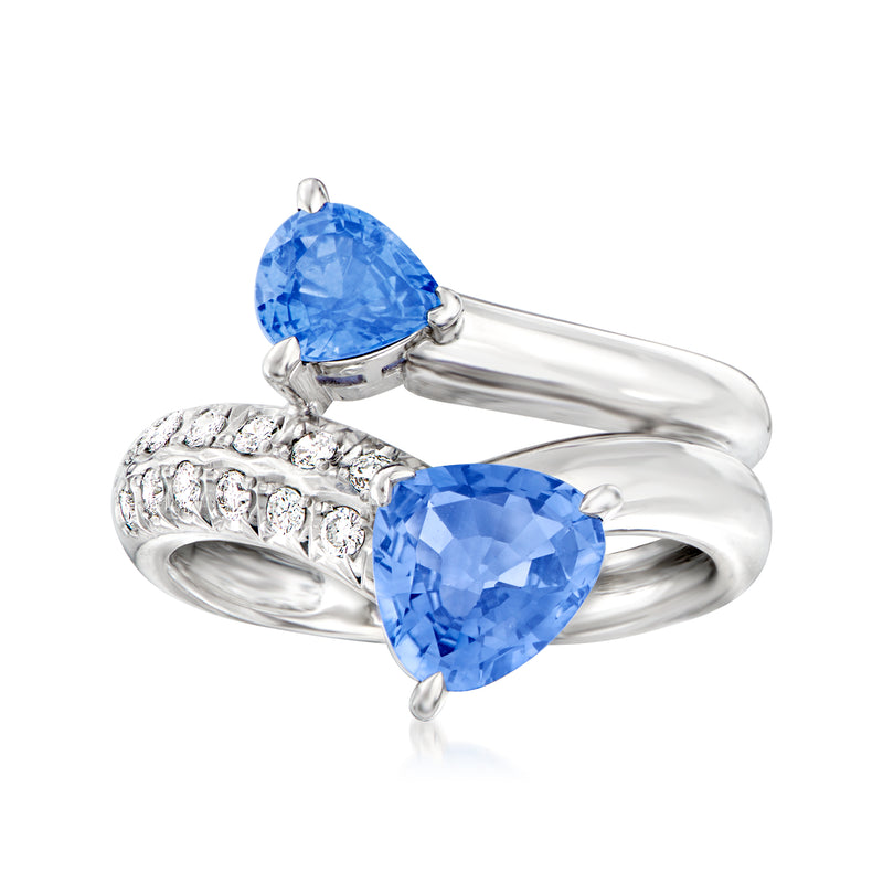 Platinum bypass ring with two oval blue sapphire stones and small diamond accents