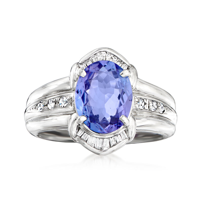 Platinum cocktail ring with oval blue tanzanite center and diamond side accents