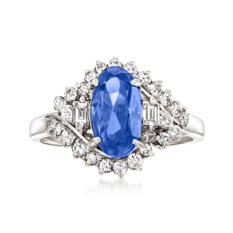 Platinum oval sapphire cocktail ring with diamond halo and side clusters