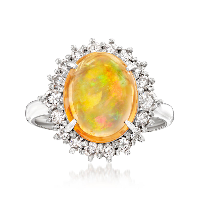 Vintage fire opal oval ring with diamond halo and platinum band