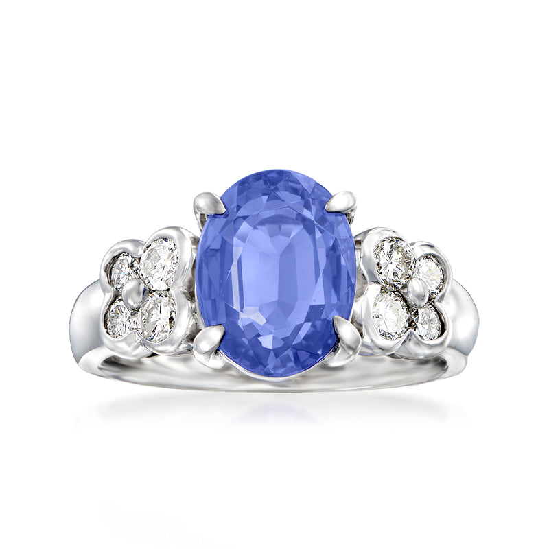Platinum vintage ring with large oval blue tanzanite center and round diamond clusters