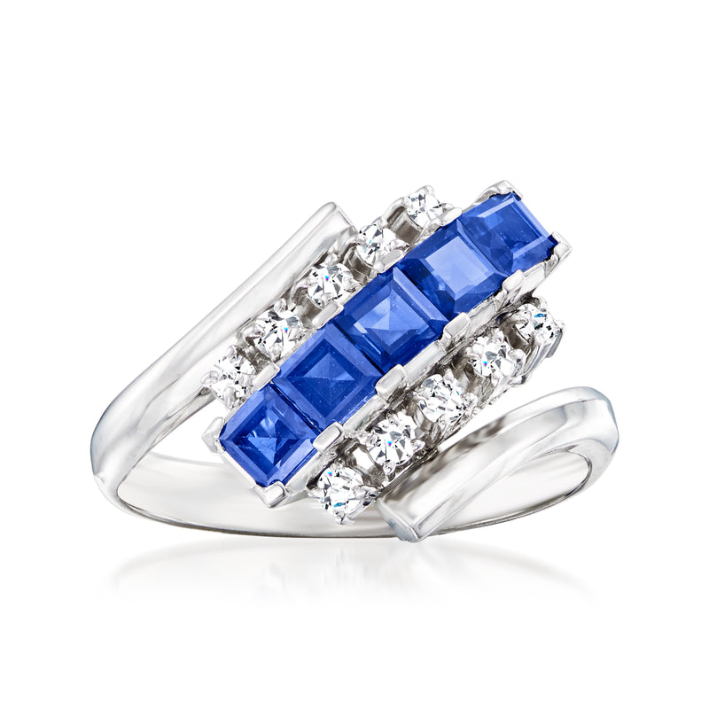 Platinum bypass ring with square blue sapphire center and diamond accents