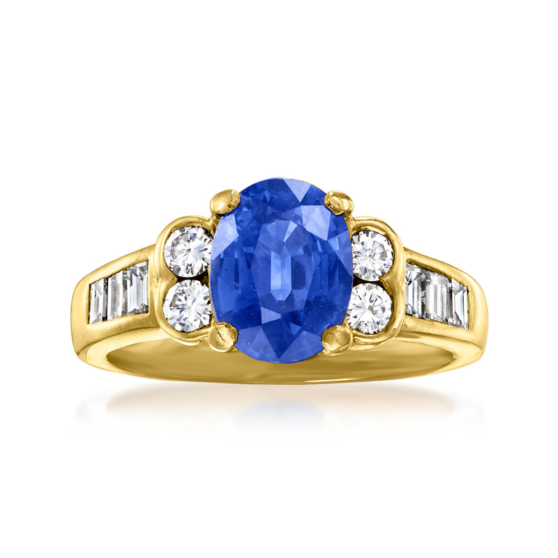 Vintage yellow gold ring with oval blue sapphire, round diamonds, and baguette diamond side stones