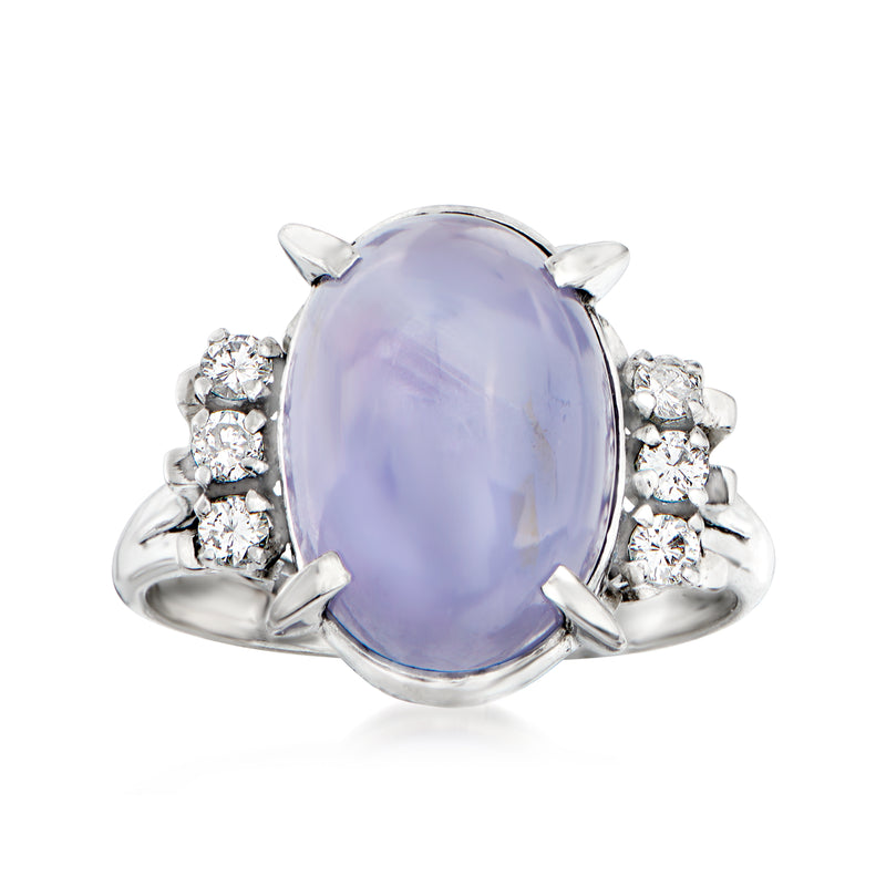 Platinum oval star sapphire ring with round diamond halo and side stones