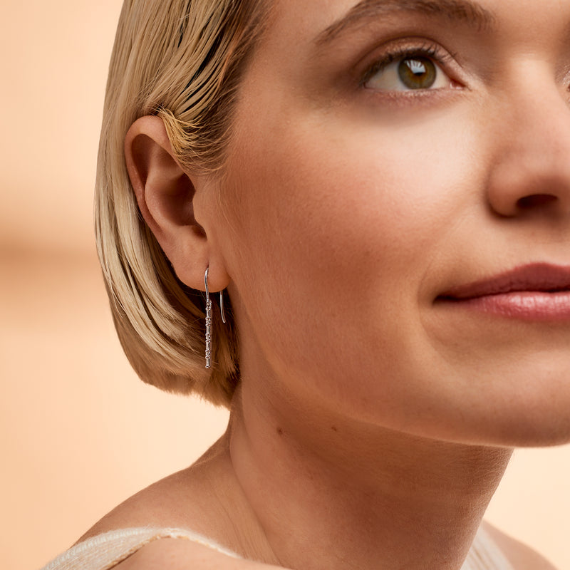 Linear drop diamond-look earrings on earwire with dangling baguette-cut stones