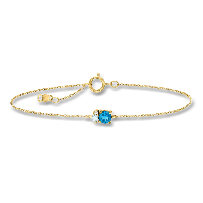 14kt yellow gold bracelet with blue topaz center stone and small charm extender