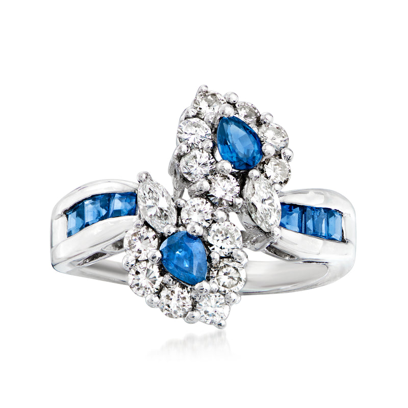 Platinum bypass ring with oval blue sapphire center and round diamond accents