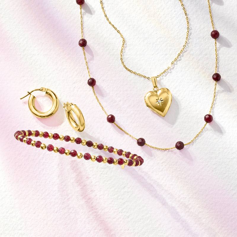 Ruby bead station necklace with 10kt yellow gold heart pendant and red bead stations.