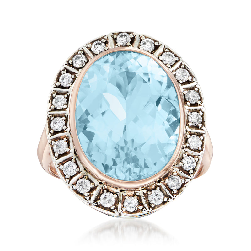 Sky-blue topaz oval cocktail ring in sterling silver and 14kt yellow gold, diamond halo
