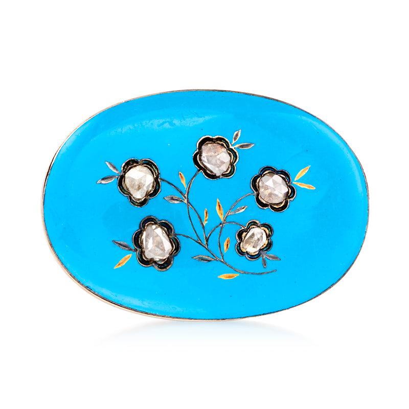 Oval blue enamel flower pin with five white stone petals and gold-tone frame