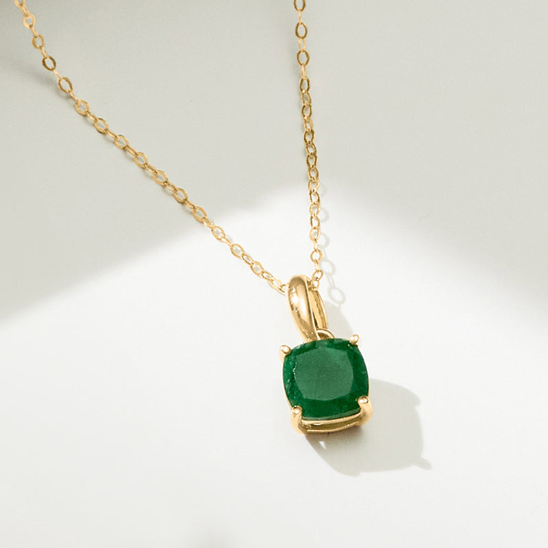 Yellow gold emerald pendant on chain with square green stone in gold bezel