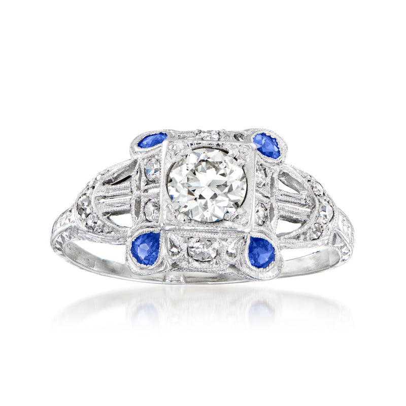 Platinum vintage-style ring with center round diamond, blue sapphire side stones