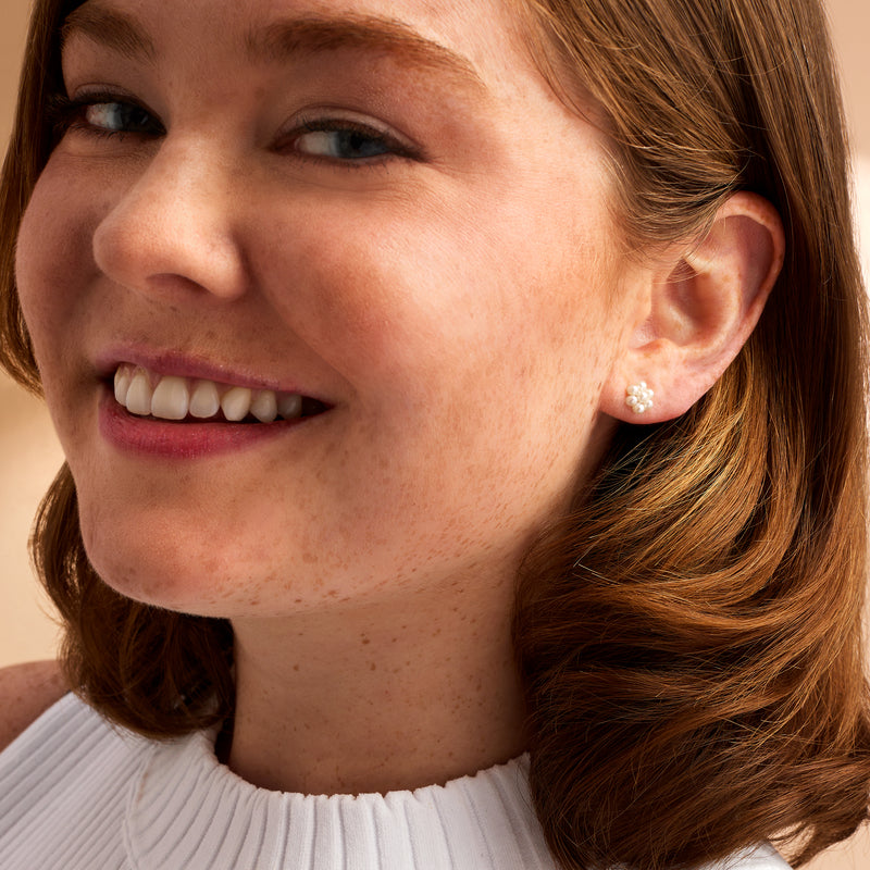 Pearl flower stud earrings, 14kt yellow gold posts, white pearls on the ear lobe