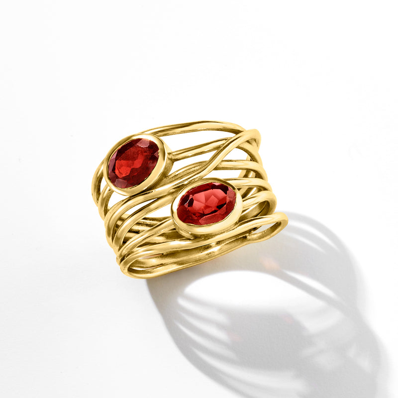 Gold over sterling garnet highway ring with two oval red stones, angled view