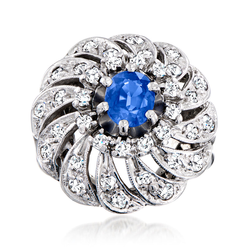 White gold swirl cocktail ring with blue sapphire center and diamond accents