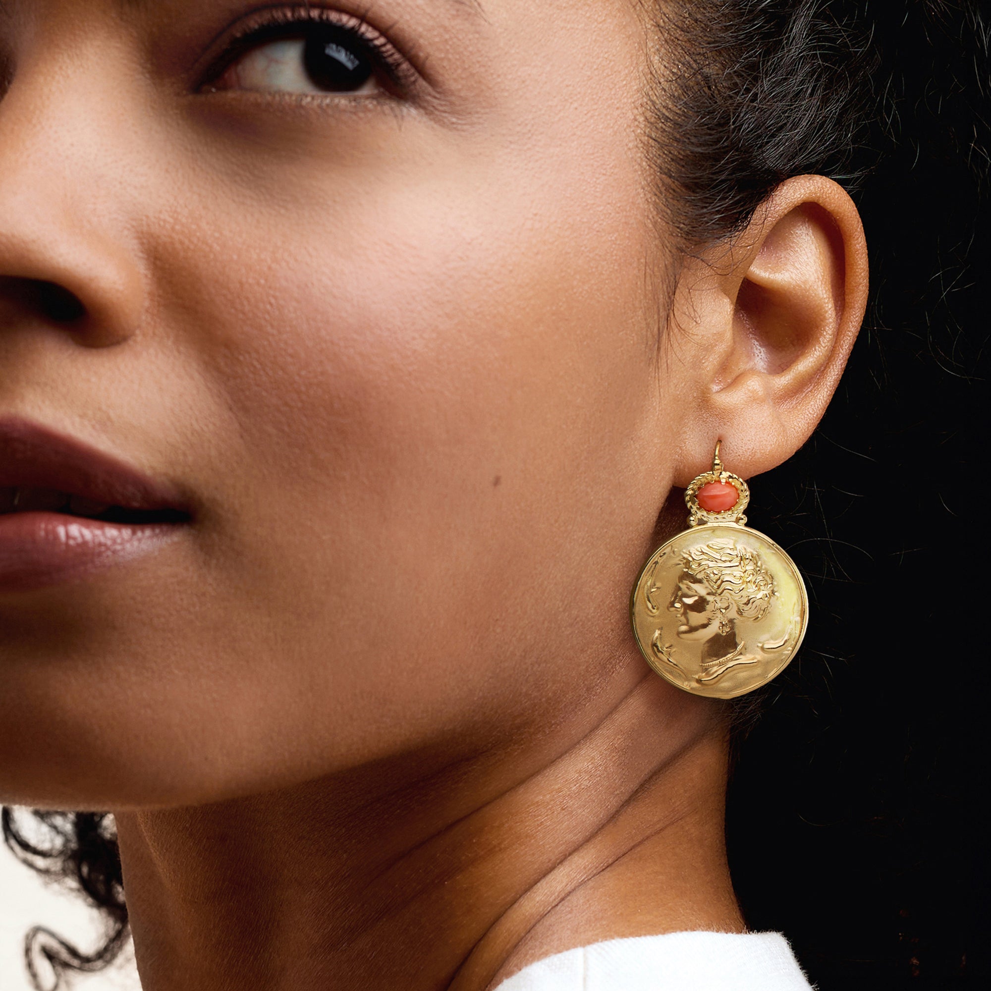 Gold Roman portrait coin drop earrings with pink coral cabochon, on ear