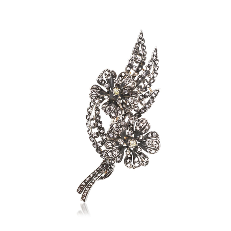 Vintage diamond floral pin with leaf design and sparkling stones in silver tone