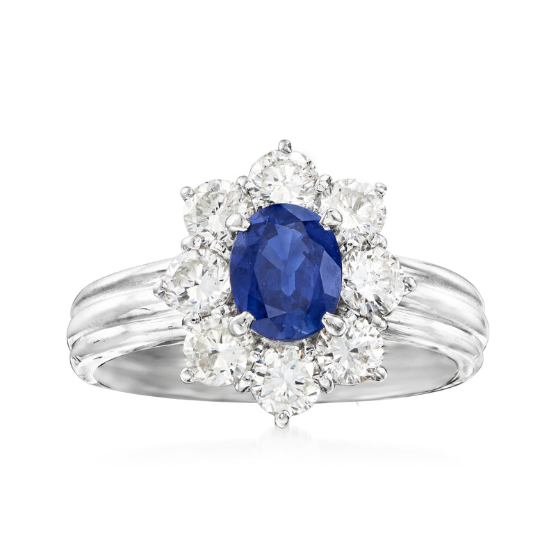 Platinum ring with oval blue sapphire center and diamond halo, plus diamond accents