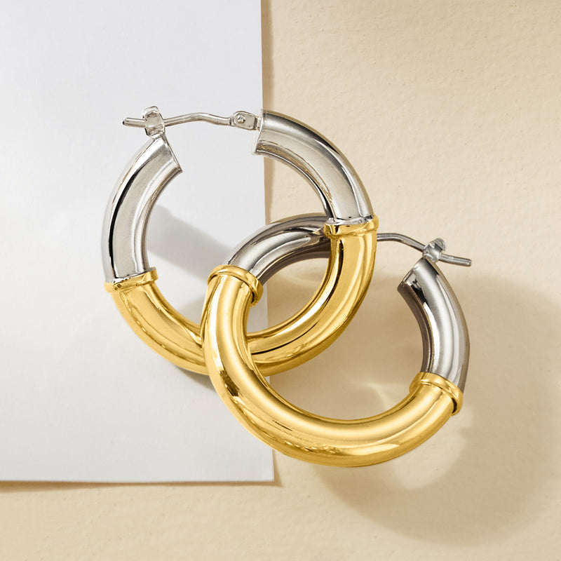 Two-tone hoop earrings, silver top with gold front curve, shown from side