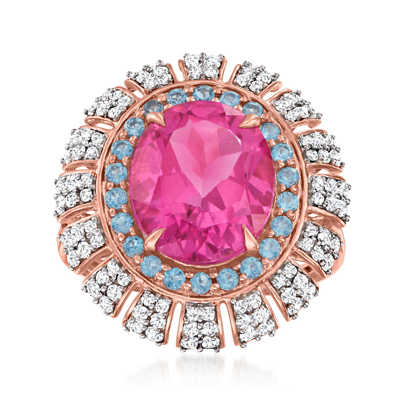 14kt rose gold ring with oval pink topaz, blue topaz halo, and diamond accents