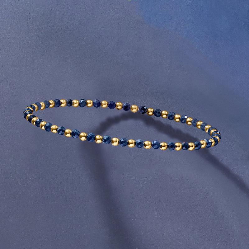 Sapphire bead stretch bracelet with dark blue beads and gold-tone round beads