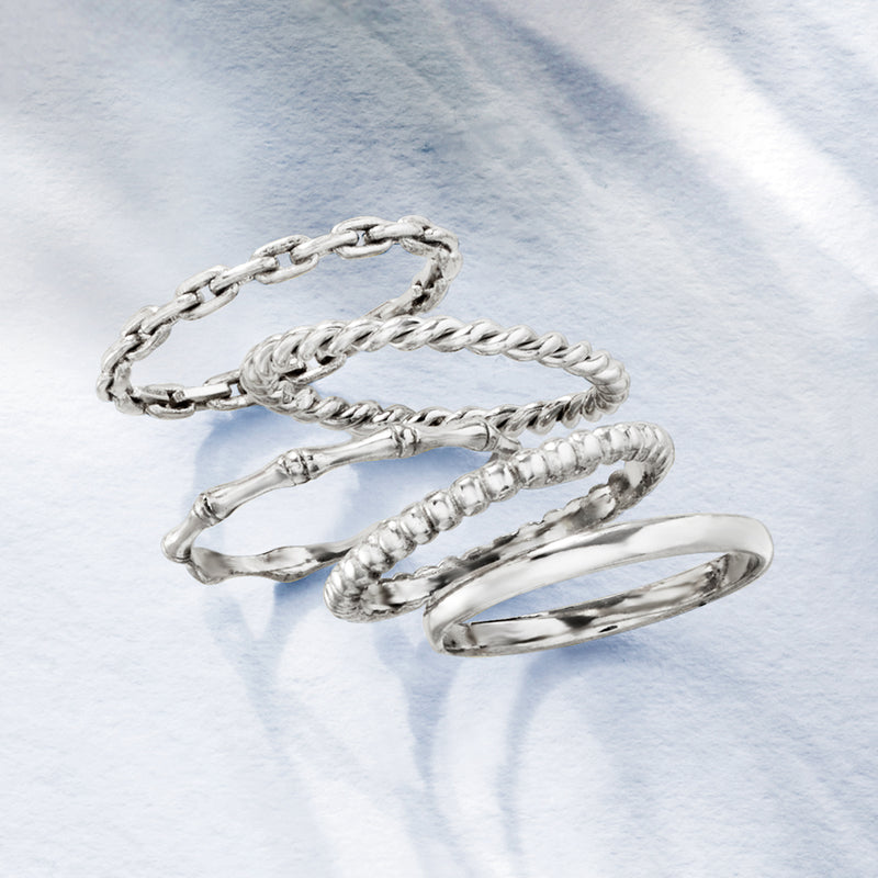 Five sterling silver stackable rings with braided, rope, and smooth finishes