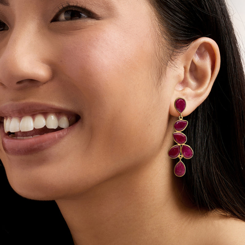 Ruby drop earrings on model, gold setting with stacked teardrop stones