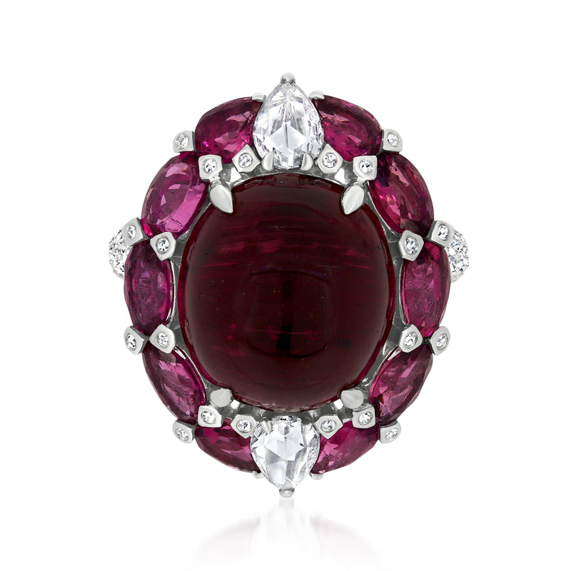 18k white gold ring with dark red oval center stone, pink side stones, and diamond accents