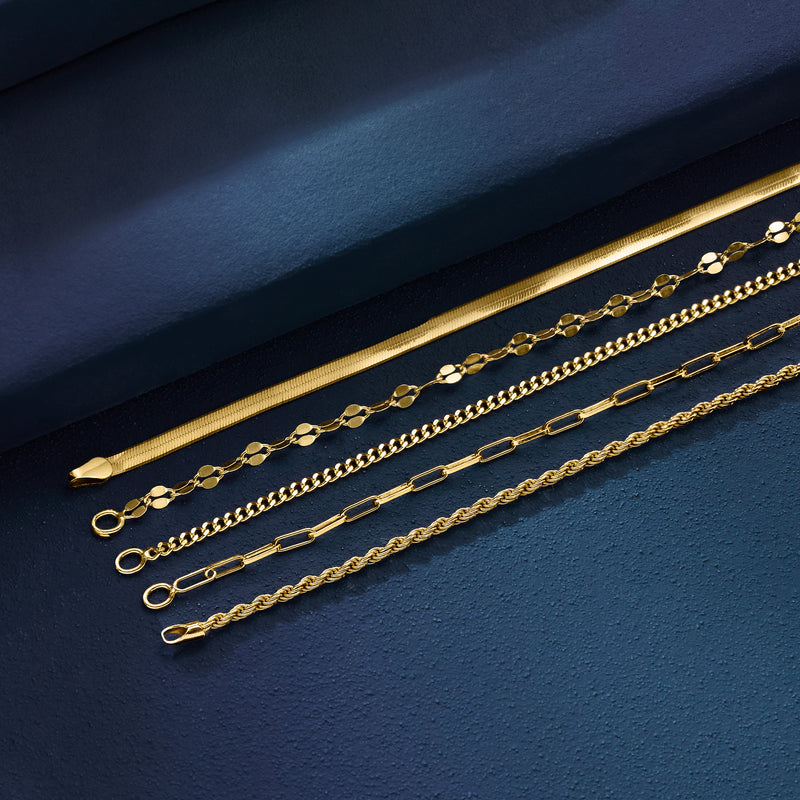 Five gold-tone chain bracelets arranged with mixed link patterns and clasps