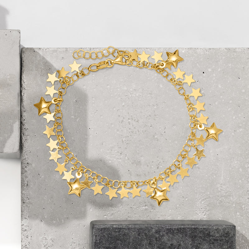 Gold star charm bracelet featuring multiple five-point star charms and extender chain