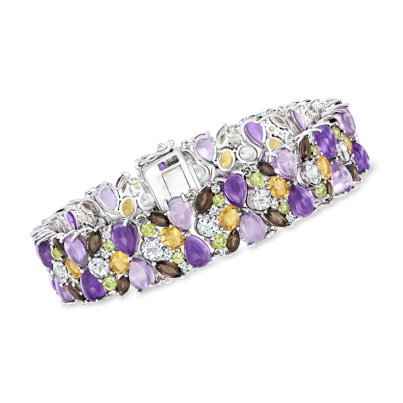Sterling silver multi-gemstone bracelet with purple, yellow, green, and clear prong-set stones