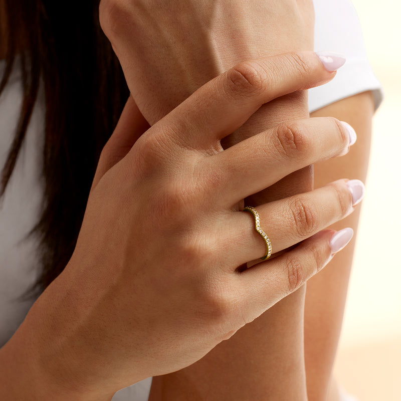 Chevron diamond ring in 14kt yellow gold worn on finger, close-up