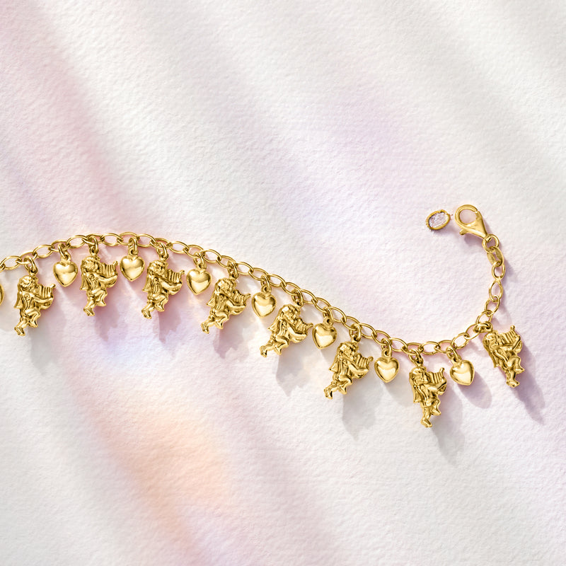 Gold-tone charm bracelet laid flat, featuring cherub and heart charms on links