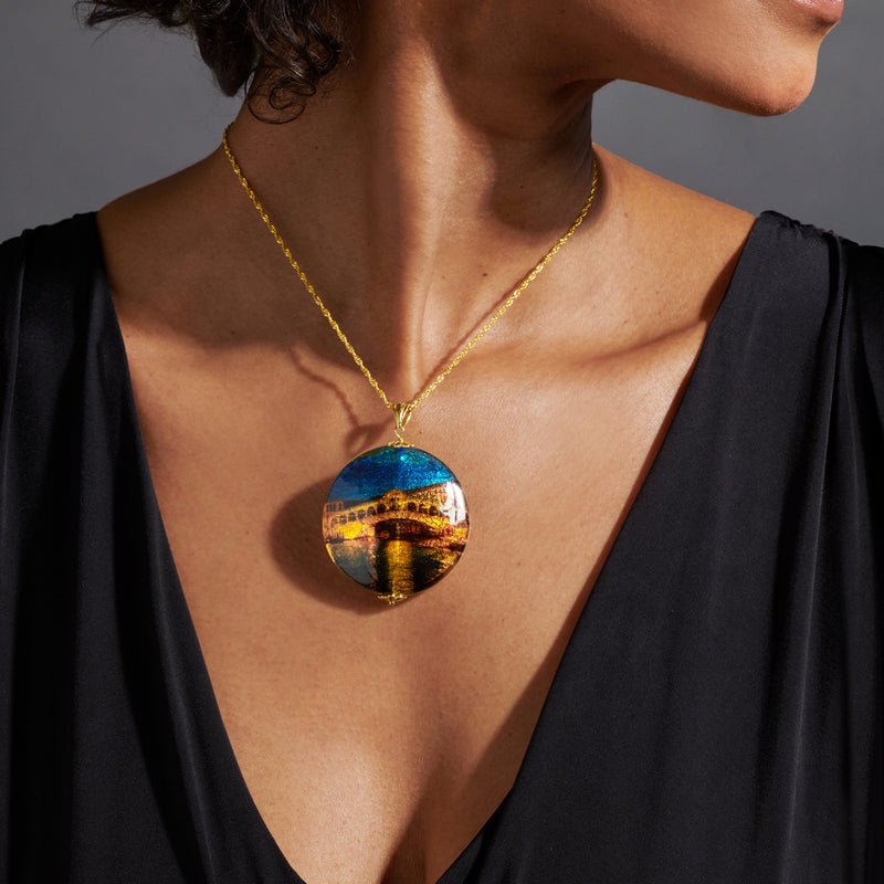Gold chain necklace with round multicolored Murano glass pendant showing bridge scene