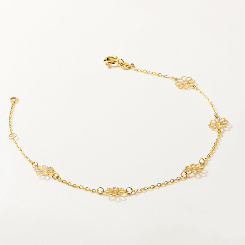 14kt yellow gold bracelet with small five-petal flower charms along the chain