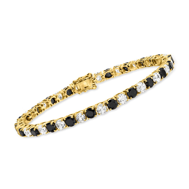 Gold tennis bracelet with alternating black and clear round stones in pave settings