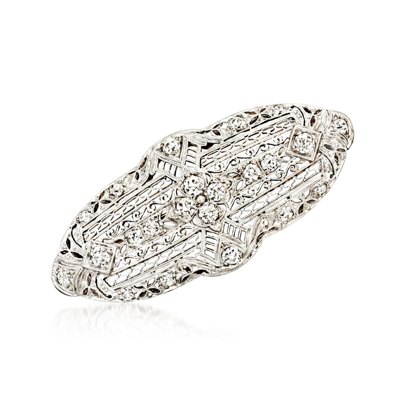 Vintage diamond filigree pin with oval platinum setting and round clear stones