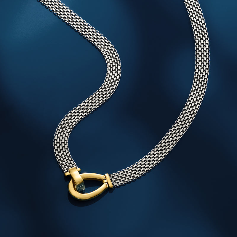Bismark-link chain necklace in silver with gold over oval clasp, angled view