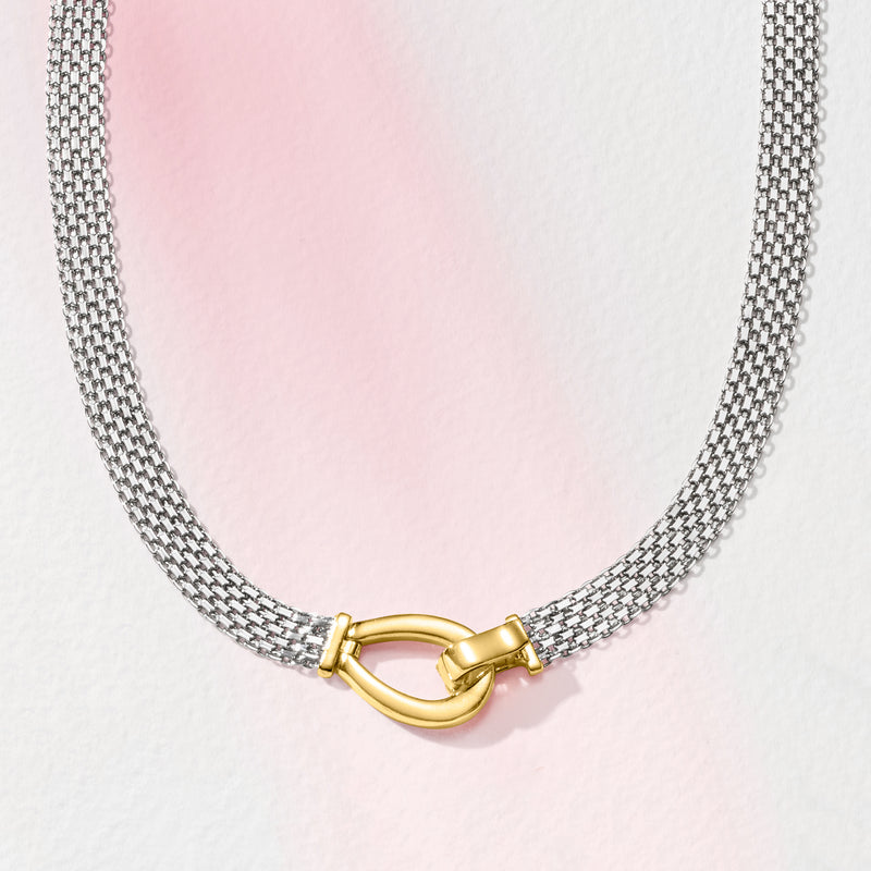 Silver bismark-link necklace with gold over clasp, centered on light background