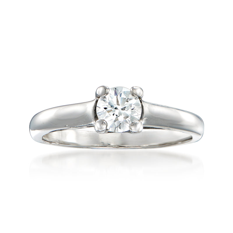 Vintage platinum diamond ring with round center stone and two small side diamonds