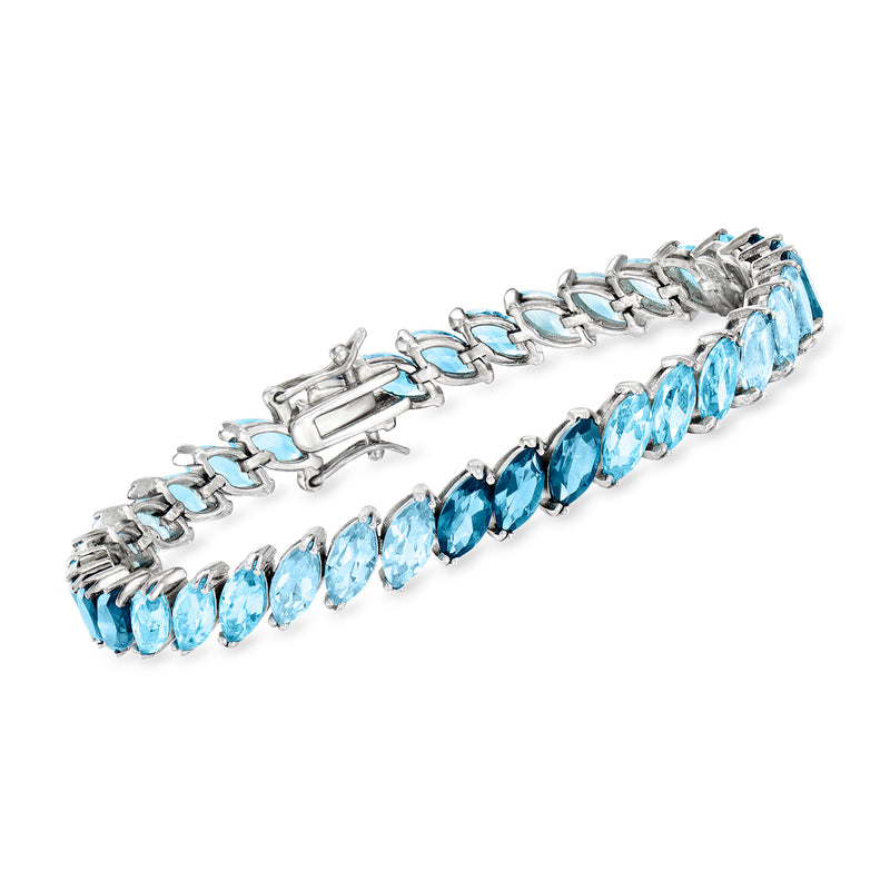 Sterling silver tennis bracelet with oval blue topaz-style gemstones, hinged clasp