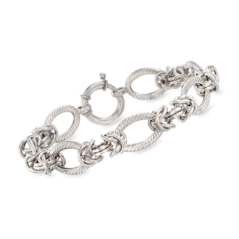 Sterling silver alternating-link bracelet with oval and rope-textured links, clasp visible.